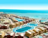 Widok z lotu ptaka na kompleks hotelowy Pickalbatros w Marsa Alam. Wiele budynków z kopułami, baseny i plaża nad Morzem Czerwonym.