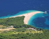 Zloty piasek i turkusowa woda na chorwackiej plaży. Idealne miejsce na bezpośrednie loty do Chorwacji.